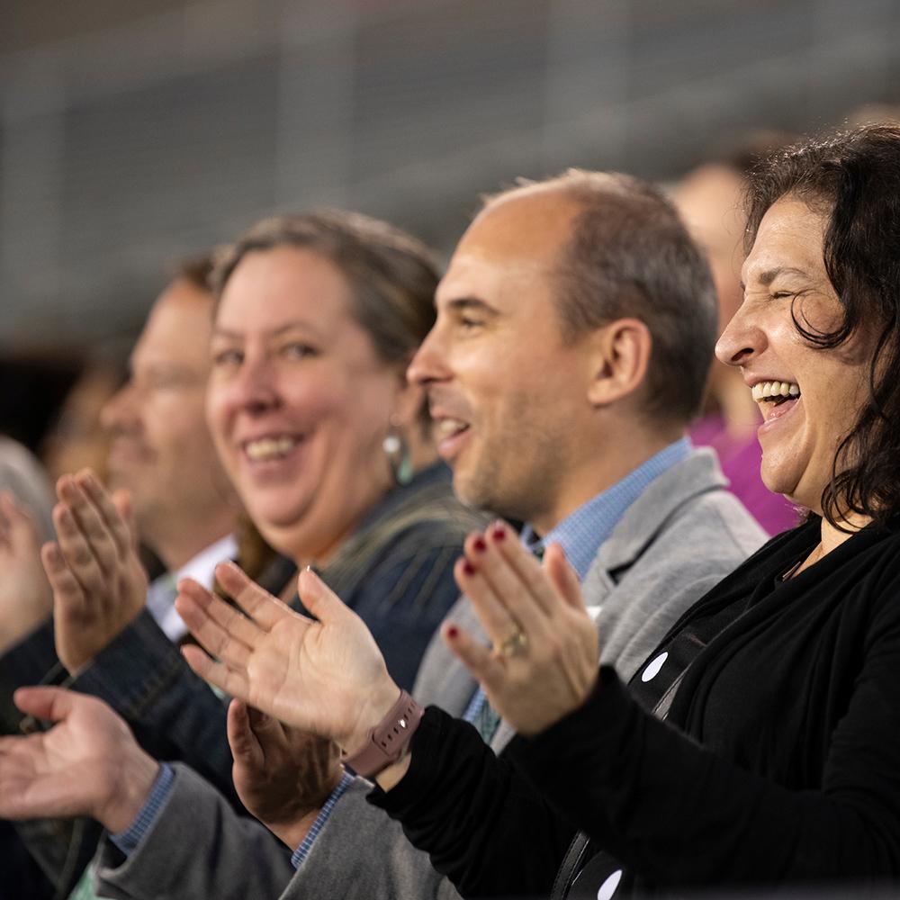 People clapping at alumni awards ceremony